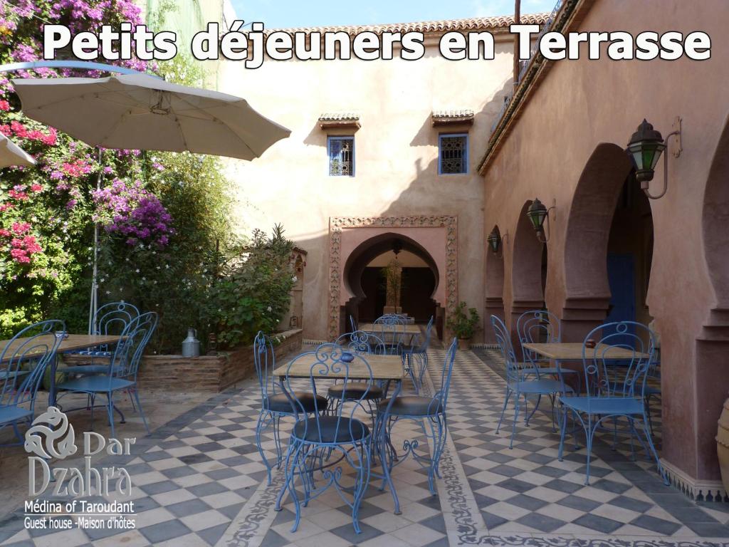 un patio avec tables, chaises et un parasol dans l'établissement Riad Dar Dzahra, à Taroudant 25 autres photos