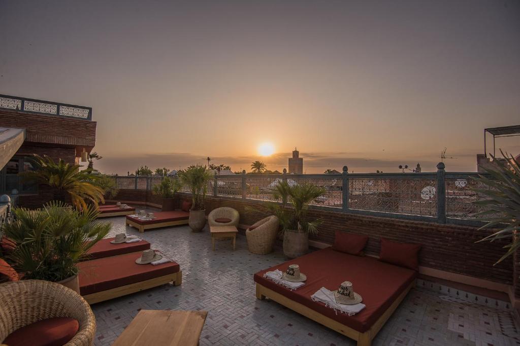 d'un toit-terrasse offrant une vue sur le coucher du soleil. dans l'établissement Riad Ksar Fawz & Spa, à Marrakech