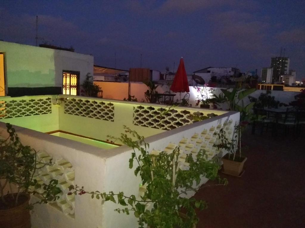d'un balcon avec un mur blanc et quelques plantes. dans l'établissement Riad El Bir, à Rabat
