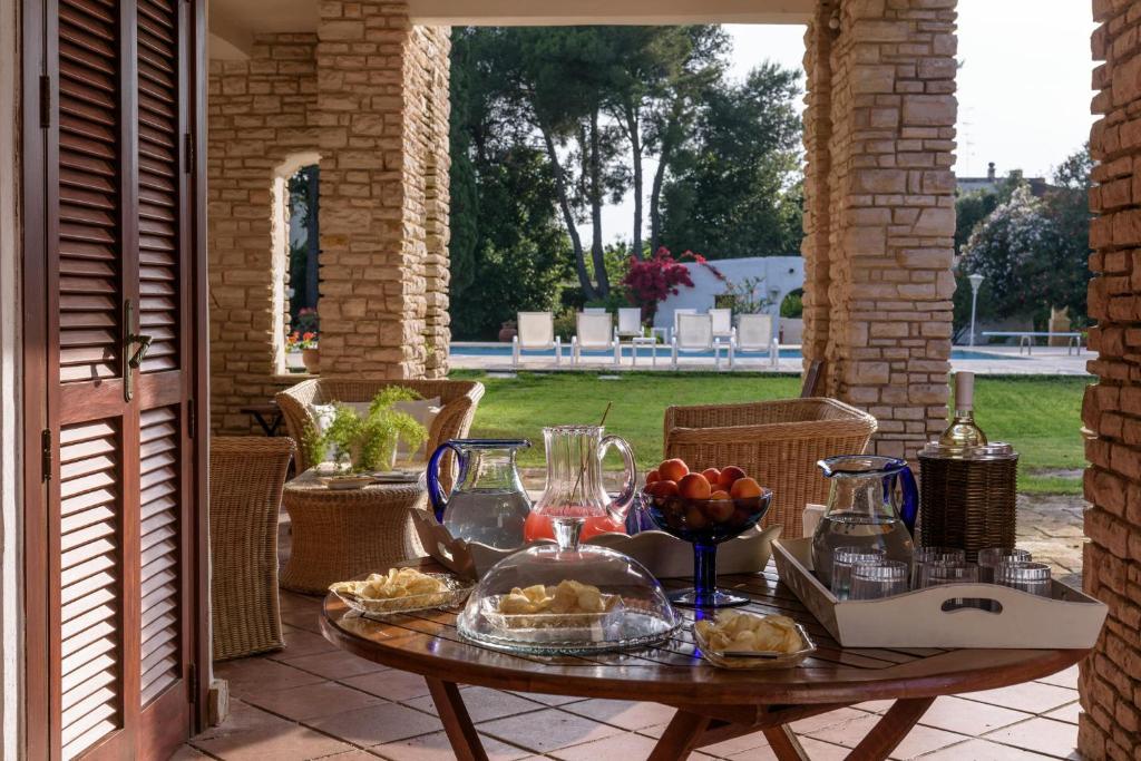 - une table avec un plateau de nourriture sur la terrasse dans l'établissement Villa Il Melograno, à San Cataldo