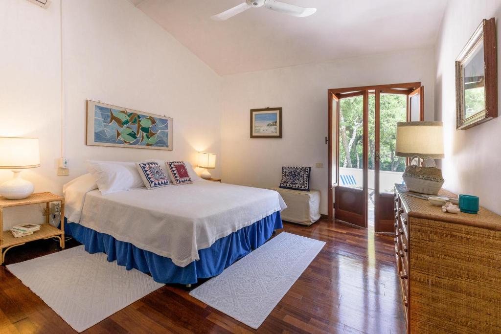 une chambre avec un lit et une porte coulissante en verre dans l'établissement Villa Il Melograno, à San Cataldo