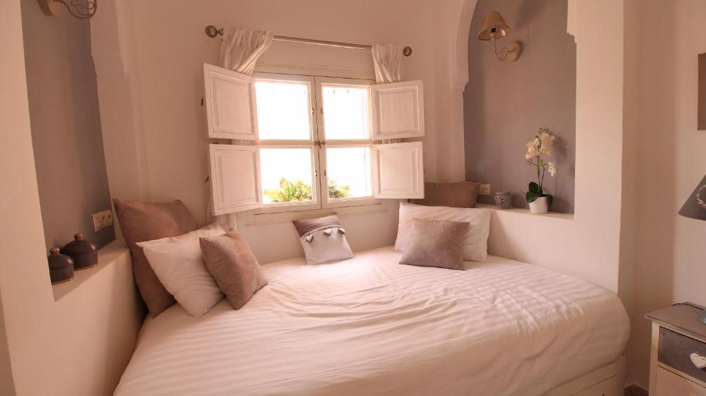 un lit dans une chambre avec une fenêtre dans l'établissement Riad Kasbah Baraka, à Marrakech