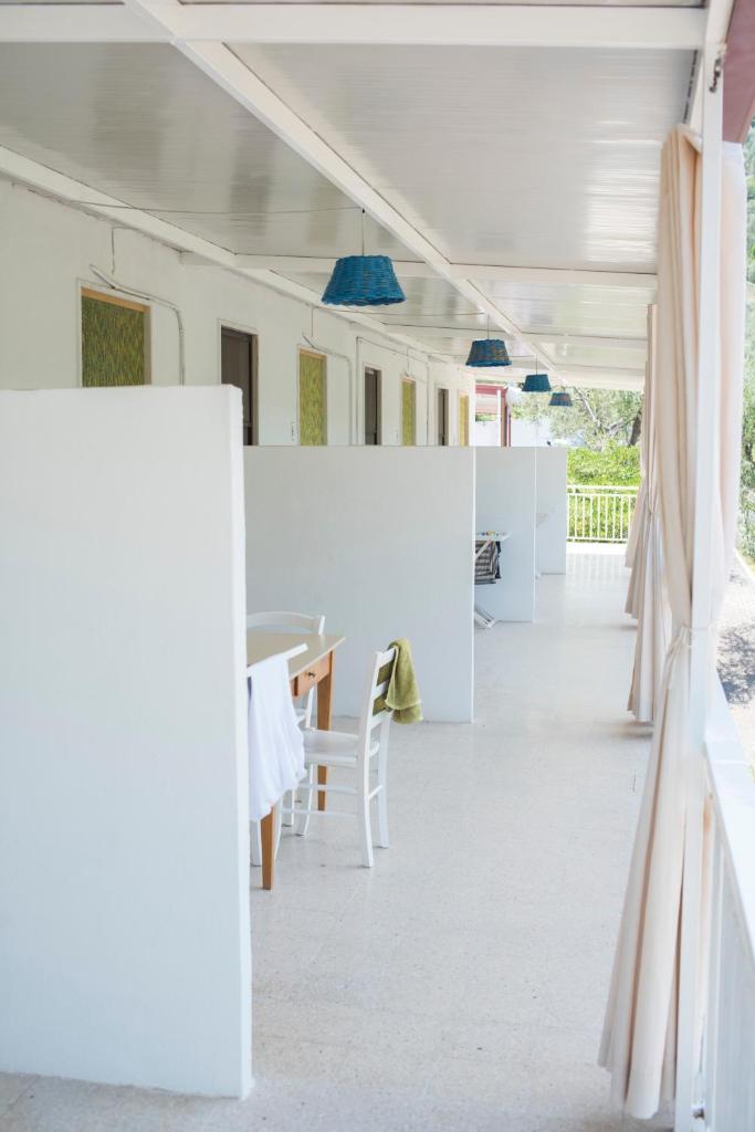 une pièce avec des murs blancs et une table et des chaises dans l'établissement Camping Apartment Vignanotica, à Mattinata