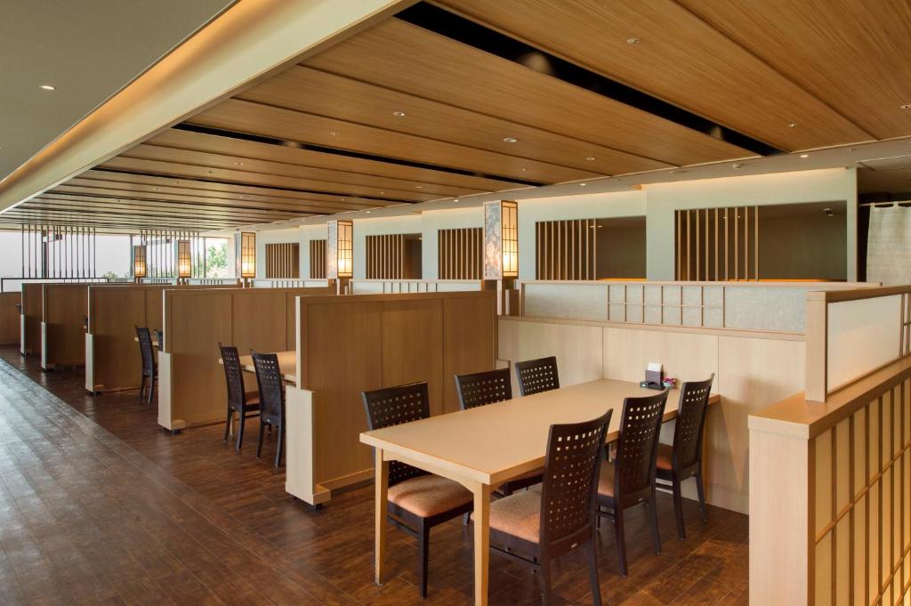 une salle à manger avec une table et des chaises dans l'établissement Kashikojima Hojoen, à Shima