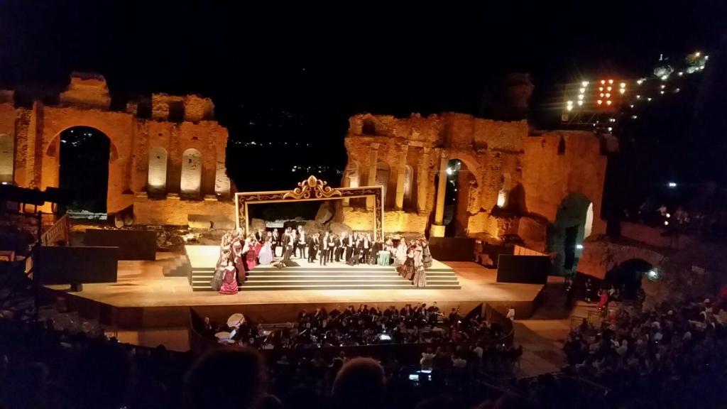 un groupe de personnes en scène la nuit dans l'établissement Taormina Villa Oasis Residence, à Taormine