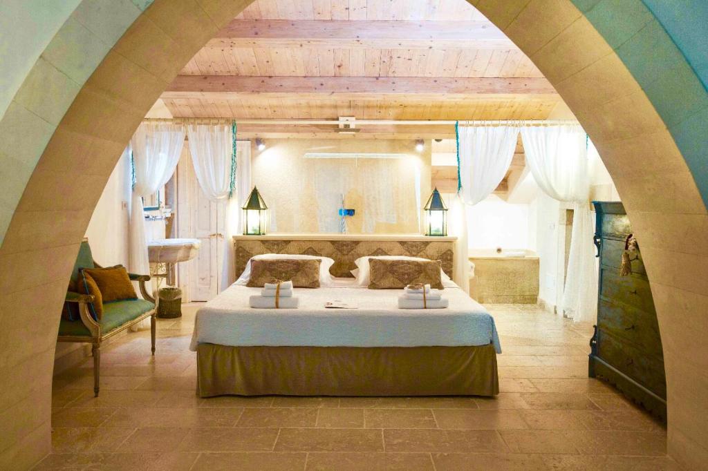 une chambre avec un grand lit dans une pièce dans l'établissement Musciara Siracusa Resort, à Syracuse