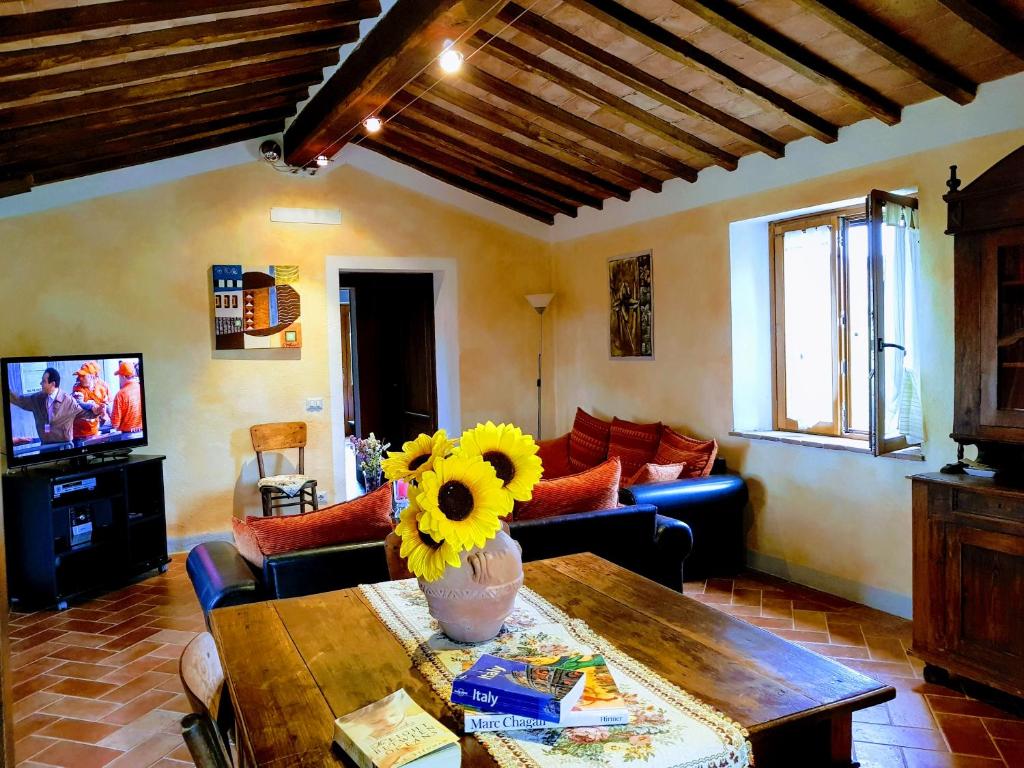 - un salon avec un vase de tournesols sur une table dans l'établissement Villa S.Anna, à Montisi