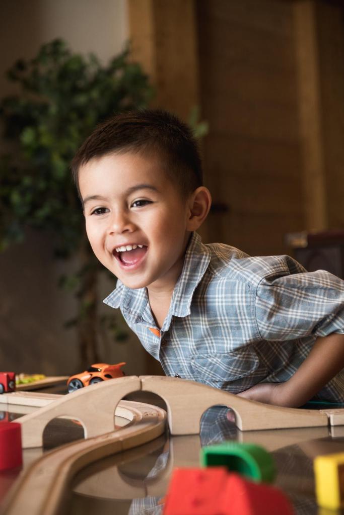 un jeune garçon souriant en jouant avec des jouets dans l'établissement CGH Résidences & Spas Le Hameau Du Beaufortain, aux Saisies 23 autres photos