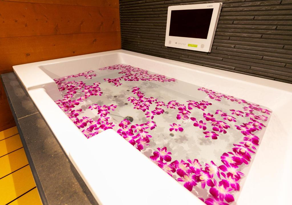 une baignoire remplie de fleurs violettes dans l'établissement HOTEL Eldia Japanese Modern (Adult Only), à Gyōda 45 autres photos