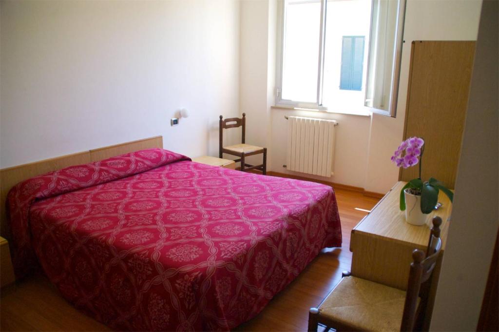 une chambre avec un lit rouge et une fenêtre dans l'établissement Hotel Ristorante Anita, à Cupra Marittima