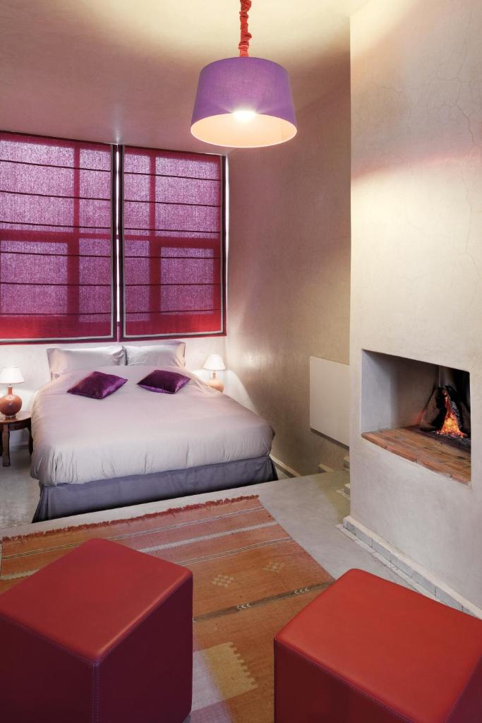 une chambre avec un lit et une cheminée dans l'établissement Dar Les Sirènes, à Essaouira