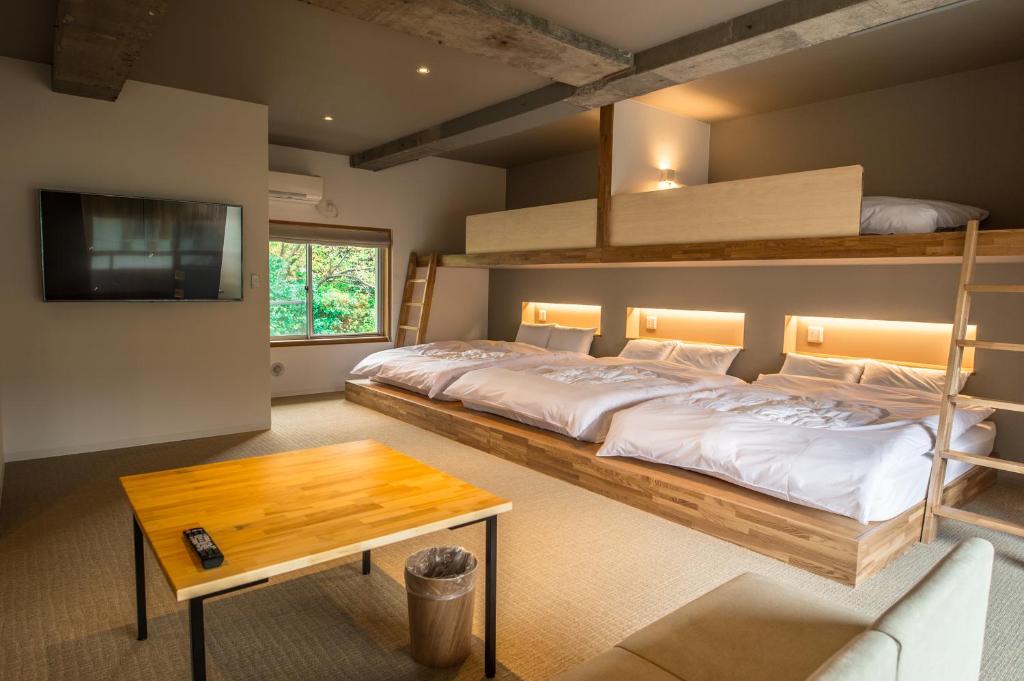 une chambre avec deux lits superposés et une table dans l'établissement WPÜ HOTEL HAKONE, à Hakone