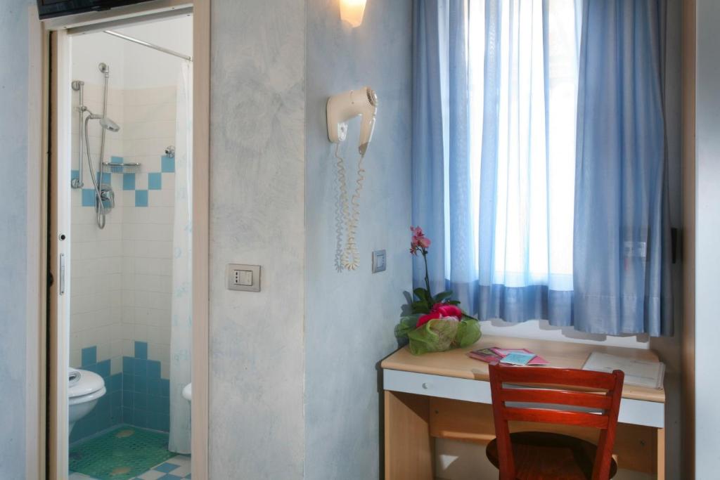 une salle de bain avec un lavabo, des toilettes et une douche dans l'établissement Hotel b&b Villa Irma, à Rimini