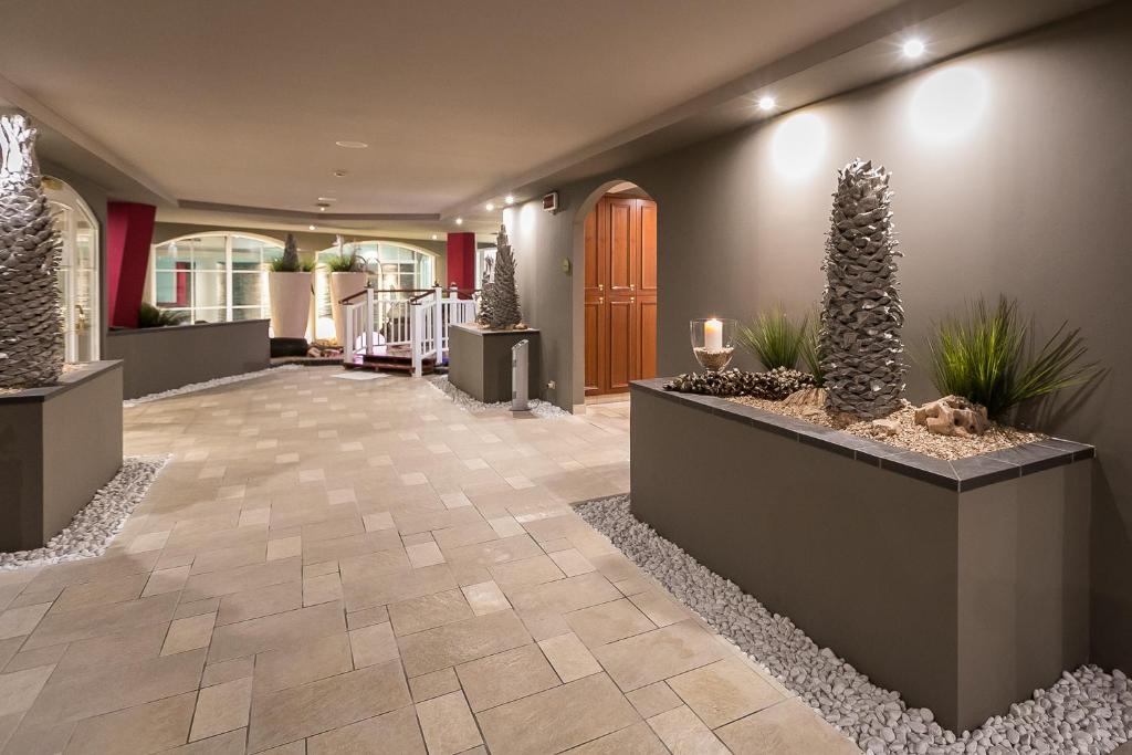un hall avec des plantes en pot et un couloir dans l'établissement Mediterranee Family Hotel & Spa, à Bibione 130 autres photos
