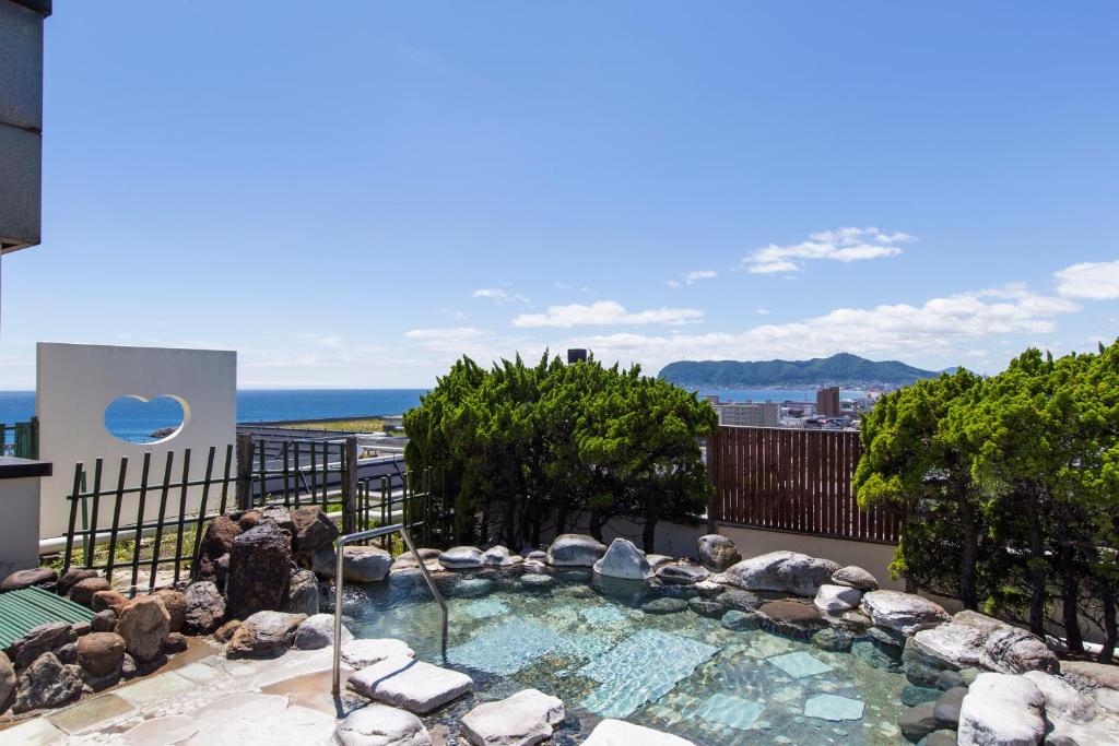 un jacuzzi sur le balcon d'un immeuble dans l'établissement Takuboku Tei, à Hakodate