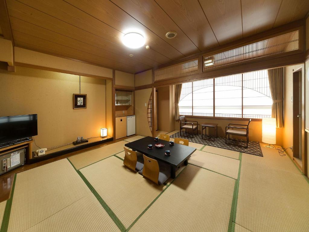 d'un salon avec une table. dans l'établissement Awara Onsen hot spring Koubou Gurabaatei, à Awara