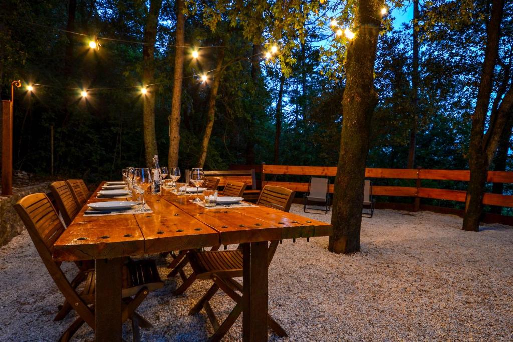 d'une table en bois avec des chaises et des lumières. dans l'établissement VillaSubasioRelax, à Spello