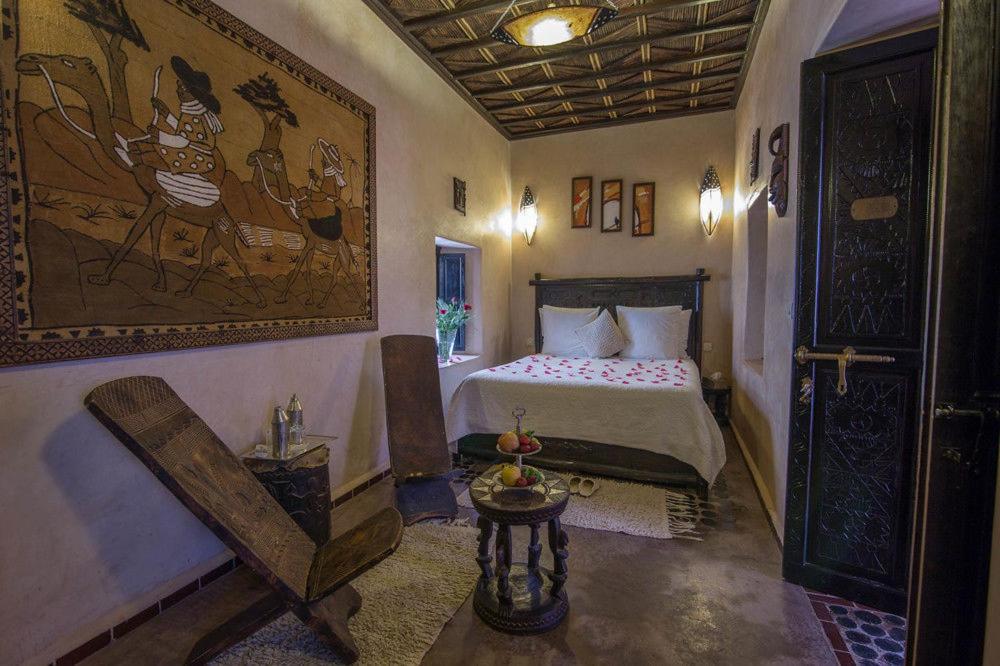 une chambre avec un lit et un tableau au mur dans l'établissement Riad Samsli, à Marrakech