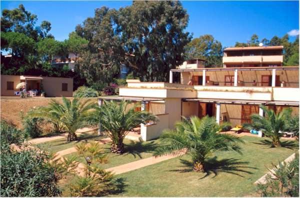 un grand bâtiment avec des palmiers devant dans l'établissement Casa Del Golfo, à Lacona
