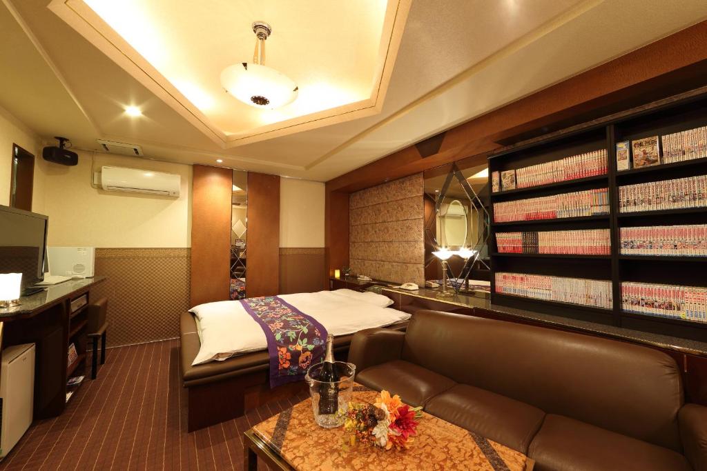 une chambre d'hôtel avec un lit et un canapé dans l'établissement Hotel La Siena (Adult Only), à Higashiōsaka 8 autres photos