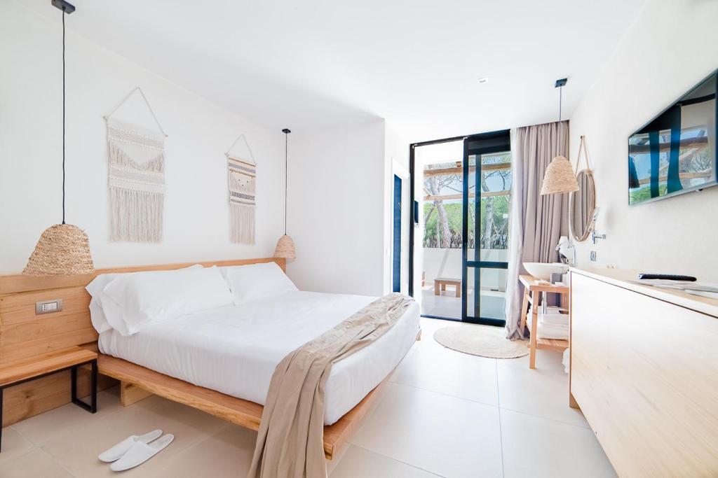 une chambre blanche avec un lit et un bureau dans l'établissement Cumeja Beach Club & Hotel, à Baia Domizia 94 autres photos