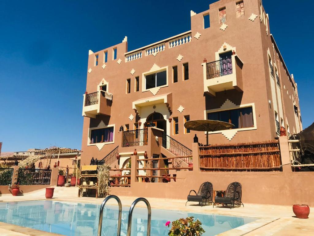 un immeuble avec une piscine devant un immeuble dans l'établissement Riad Dar Bab Todra, à Tinghir
