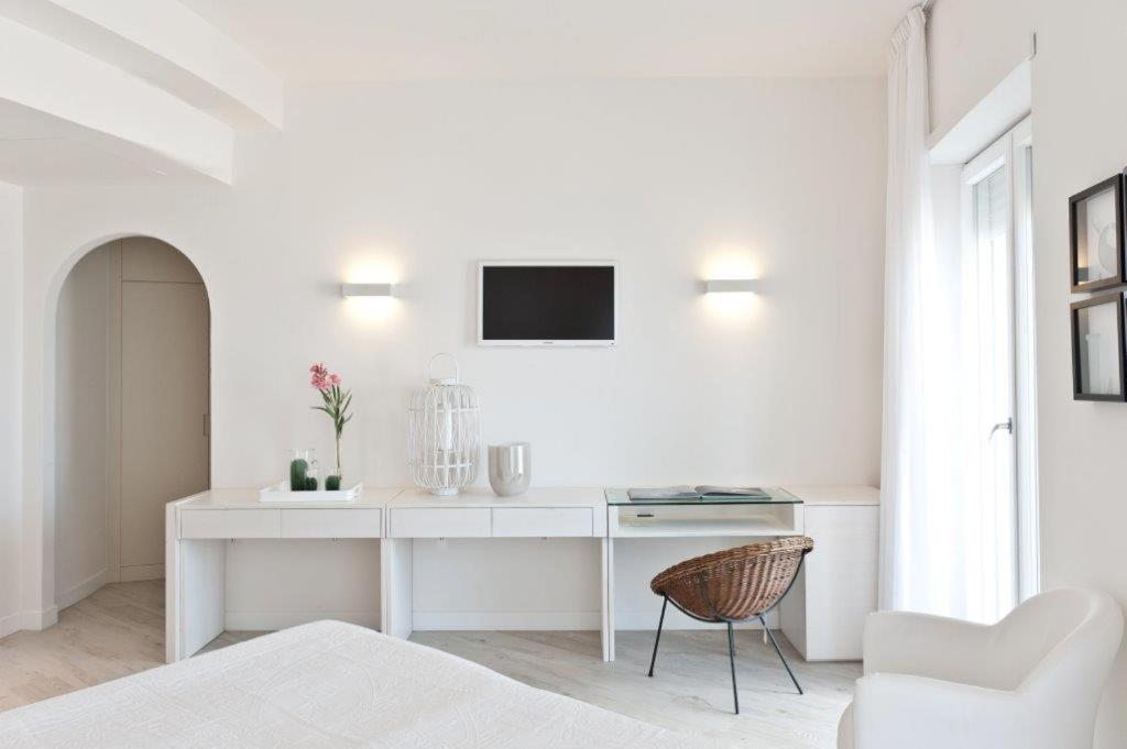 Cette chambre blanche dispose d'un bureau et d'une télévision murale. dans l'établissement Hotel Torremaura, à Milano Marittima