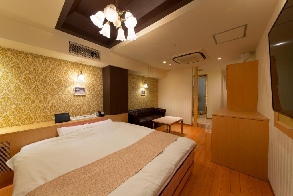 une chambre avec un grand lit dans une pièce dans l'établissement Hotel Luna Sakuranomiya (Adult Only), à Osaka