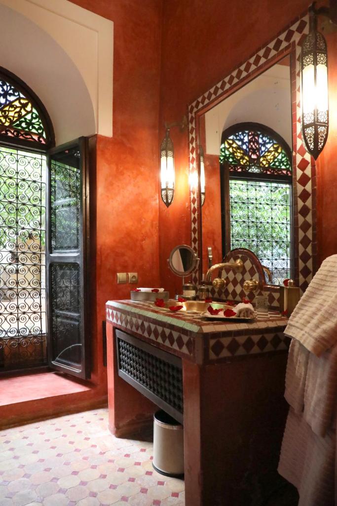 une salle de bain avec un lavabo et un miroir dans l'établissement Riad ILayka, à Marrakech