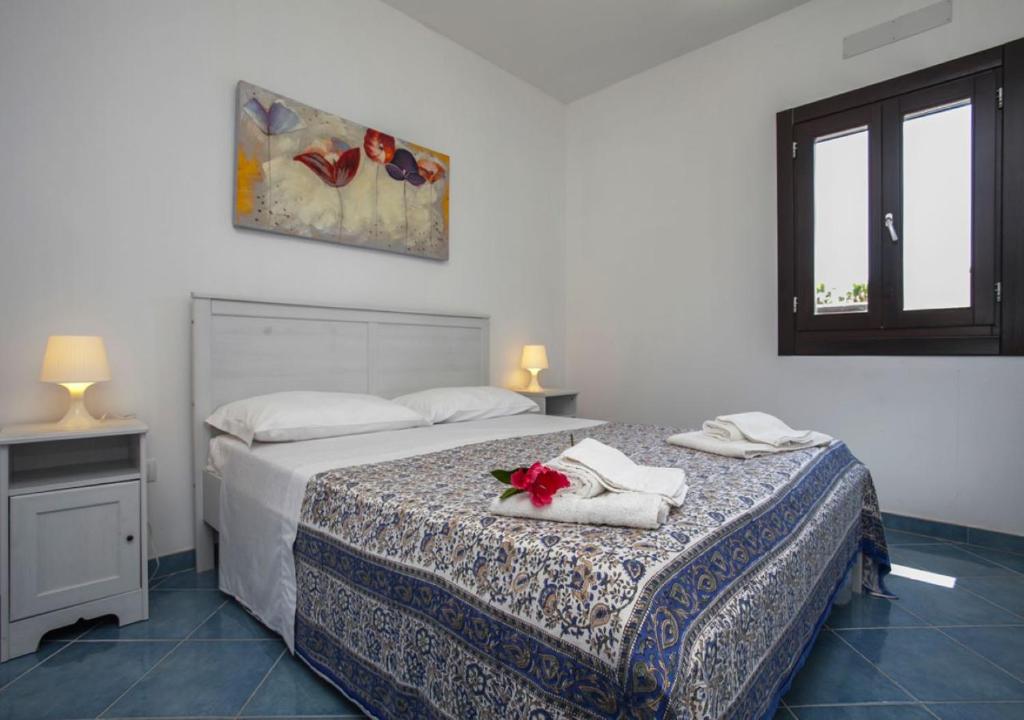 - une chambre avec 2 lits, des serviettes et une fenêtre dans l'établissement Chiusurelle Village Resort, à Punta Prosciutto