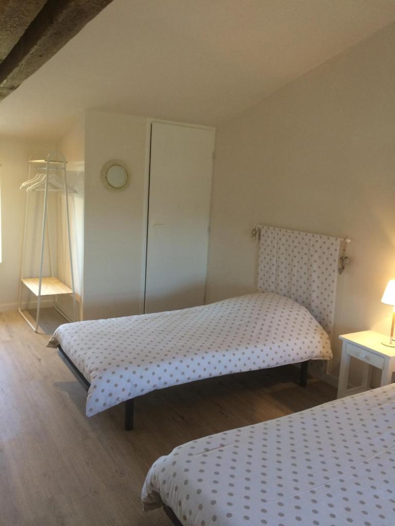 - une chambre avec 2 lits et une commode dans l'établissement LE PETIT MONTY Gite Cote Etang, à Saint-Malo-du-Bois