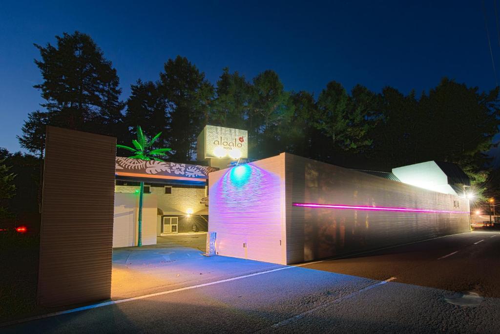 - un bâtiment avec des lumières violettes la nuit dans l'établissement aloalo, à Fujikawaguchiko