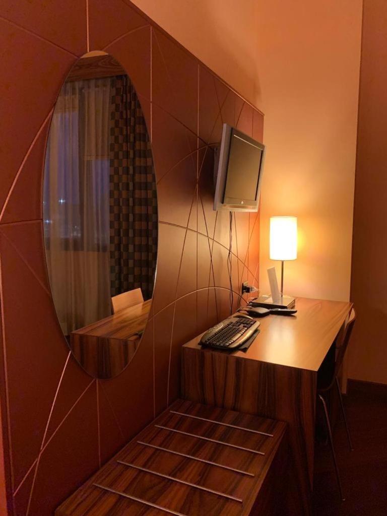 Cette chambre comprend un bureau avec un ordinateur et un miroir. dans l'établissement Laghi Room Only, à Sibari