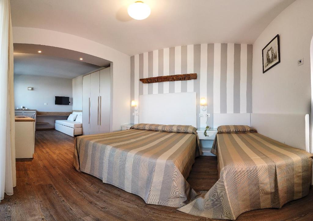 une chambre d'hôtel avec deux lits dans une chambre dans l'établissement Hotel Derby Exclusive, à Milano Marittima