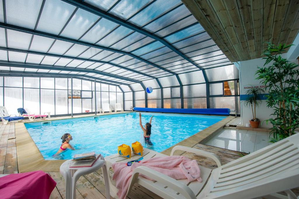 - une piscine avec 2 enfants jouant dans l'eau dans l'établissement Résidence Goélia Le Village Gaulois, à Saint-François-Longchamp 16 autres photos