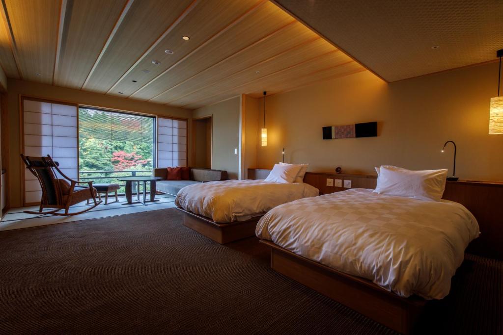 une chambre d'hôtel avec deux lits et un salon dans l'établissement Nakanobo Zuien (Adult Only), à Kobe