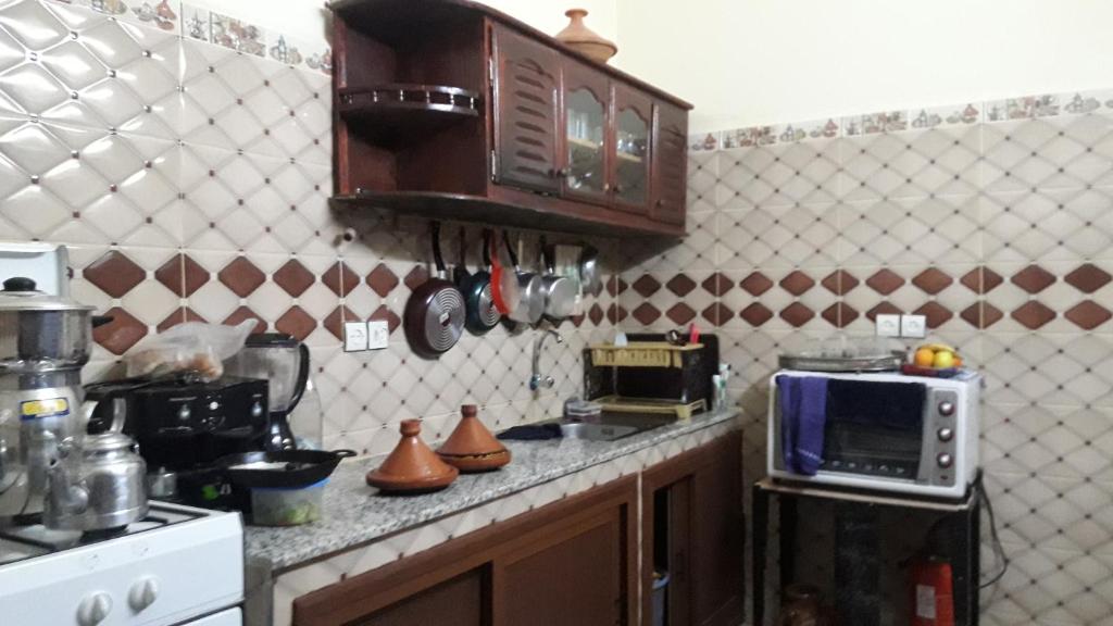une cuisine avec un comptoir avec un micro-ondes dans l'établissement Dar nadaa, à Fès