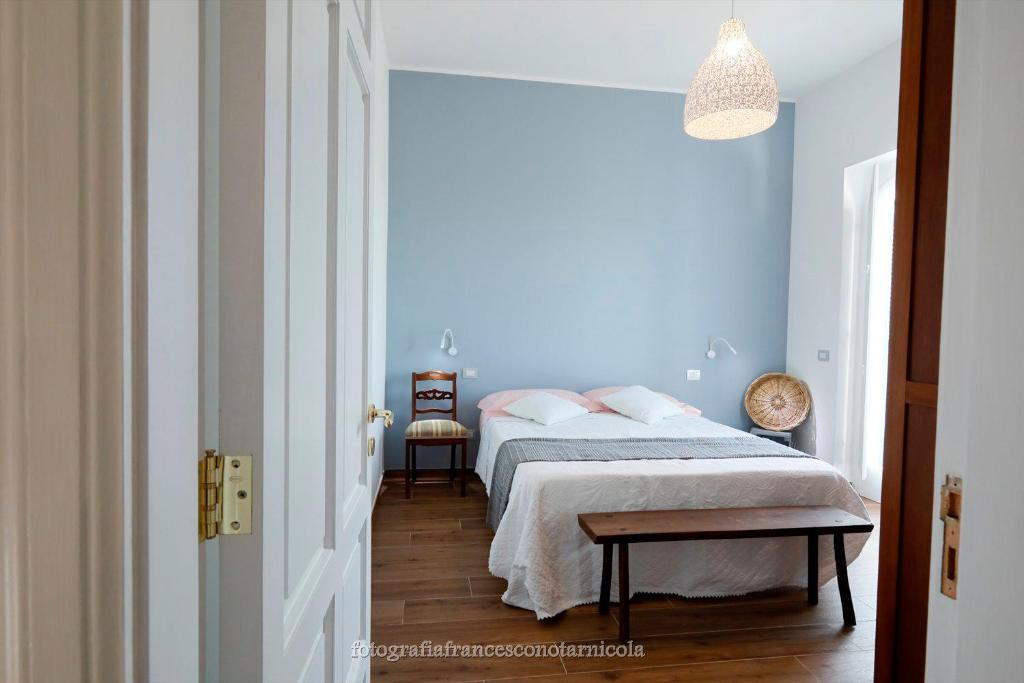 une chambre avec deux lits et un mur bleu dans l'établissement Residenza Lippolis, à Castellana Grotte