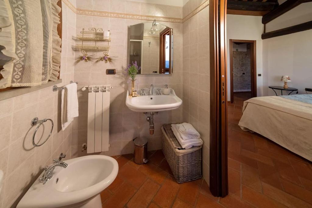 une salle de bain avec un lavabo, un miroir et un lit dans l'établissement Villa San Giorgio, à Montemurlo 34 autres photos