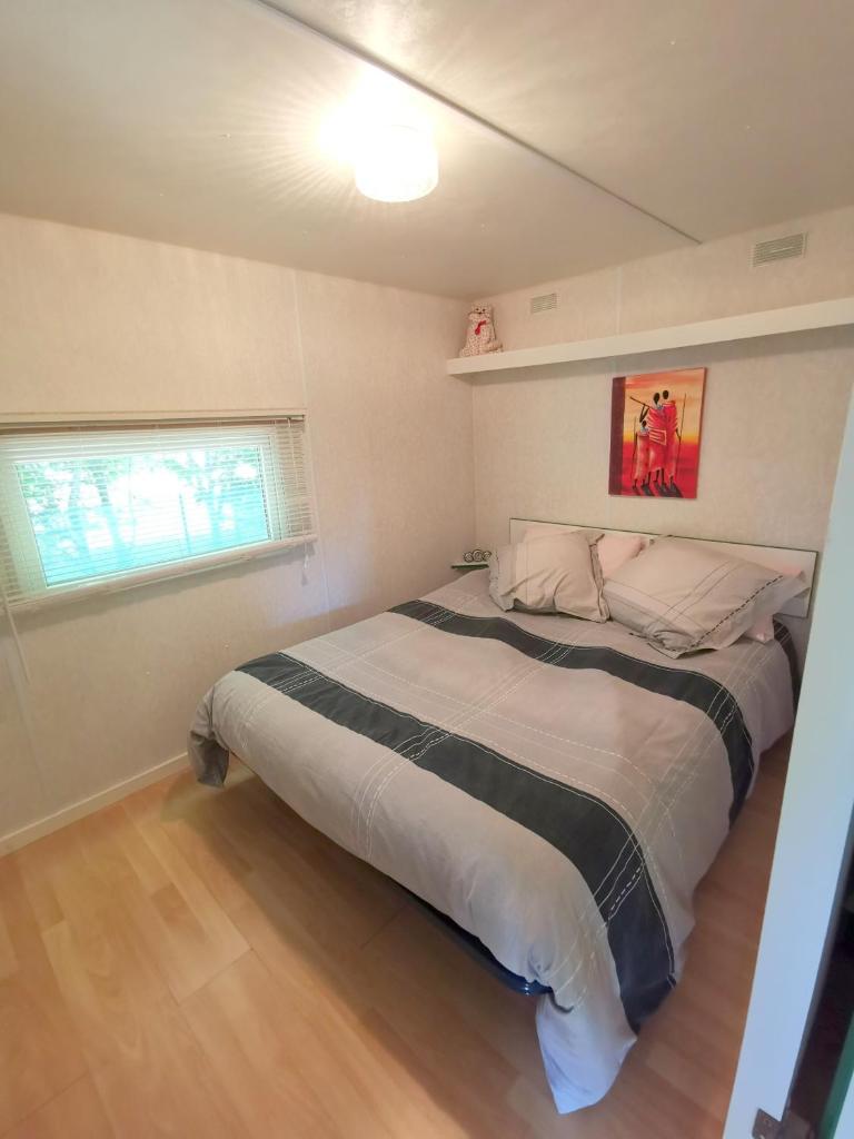 une chambre avec un grand lit dans une pièce dans l'établissement Mobile Home at La Petite Lande, à Pierrefiche 25 autres photos