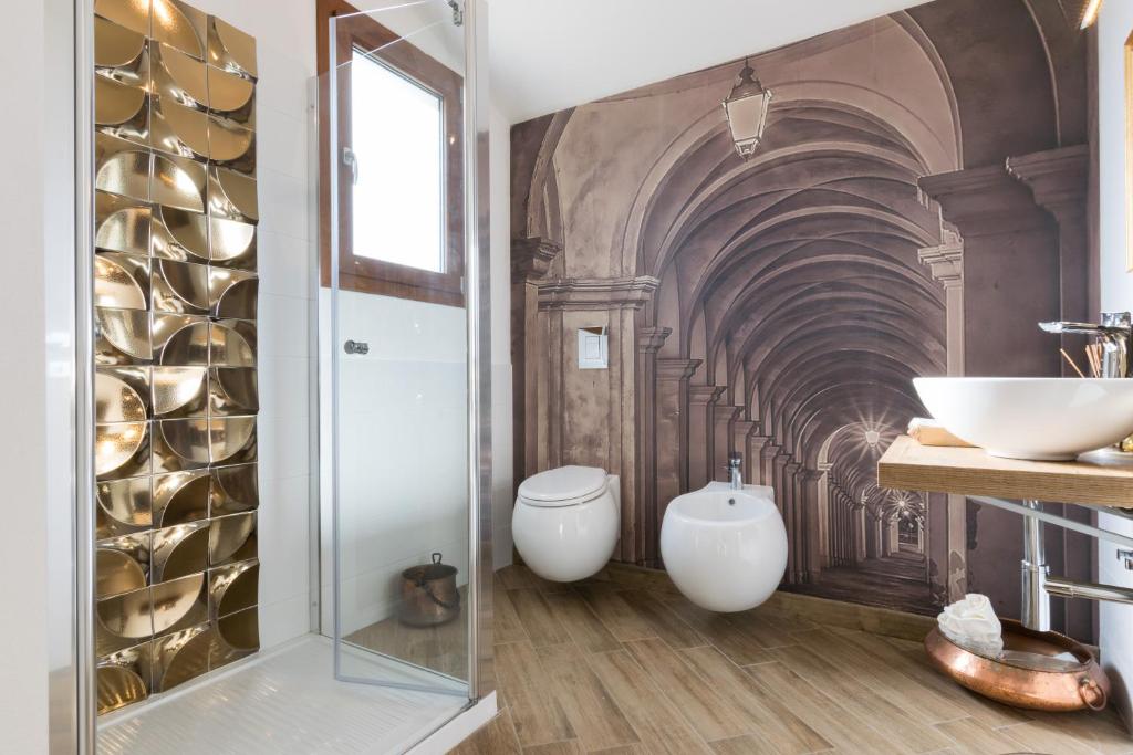 une salle de bain avec deux lavabos et une douche en verre dans l'établissement Villa Dama luxury, à Alghero