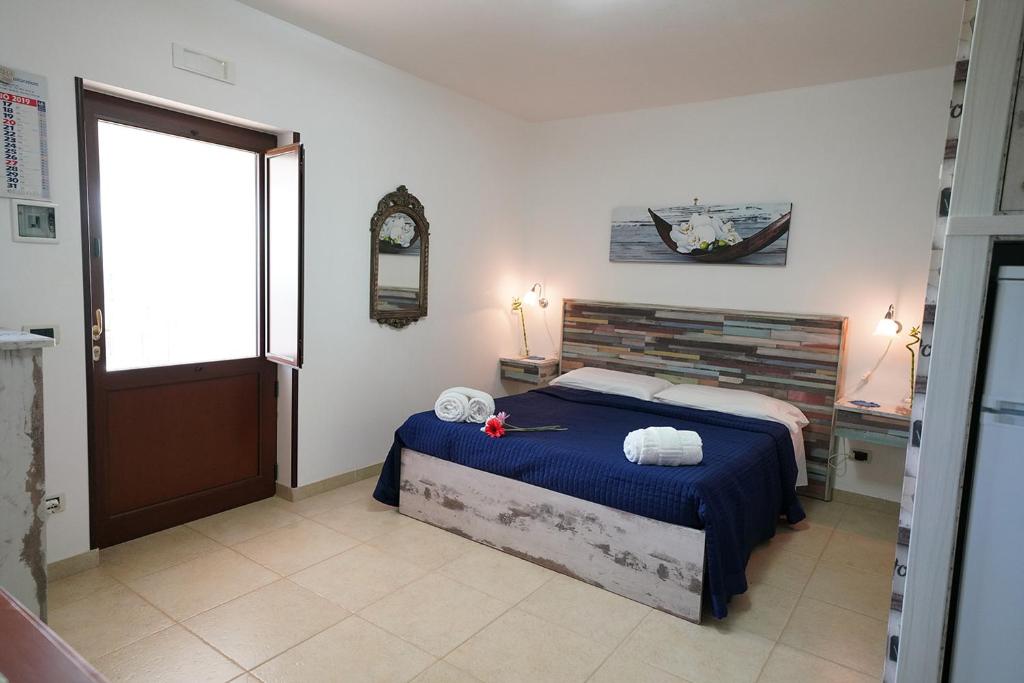 une chambre avec un lit avec des draps bleus et une fenêtre dans l'établissement Villa Belvedere, à Ostuni 79 autres photos