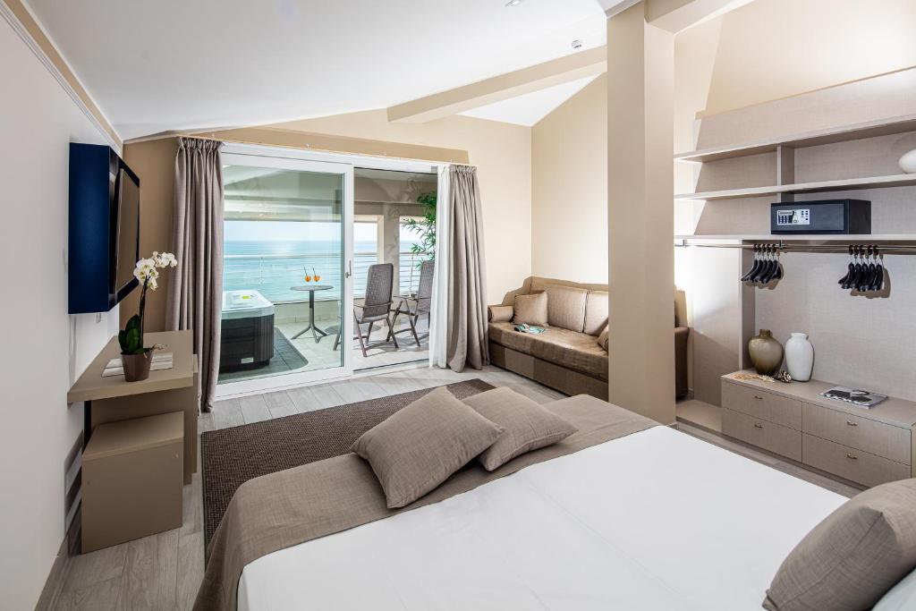 une chambre avec un lit et un salon dans l'établissement Hotel Capitol, à Lido di Jesolo