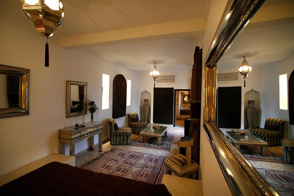 - un grand salon avec un canapé et des chaises dans l'établissement Riad Assakina, à Marrakech