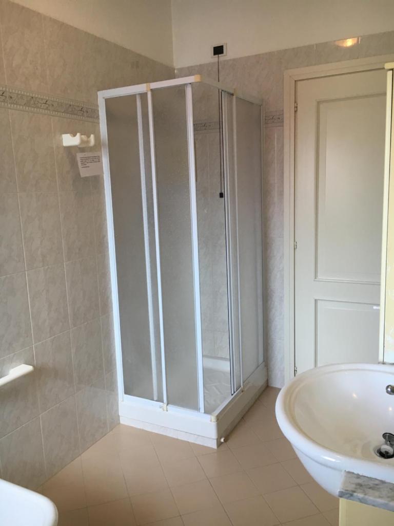 une salle de bain avec douche et lavabo dans l'établissement Hotel Gianna, à Roseto degli Abruzzi