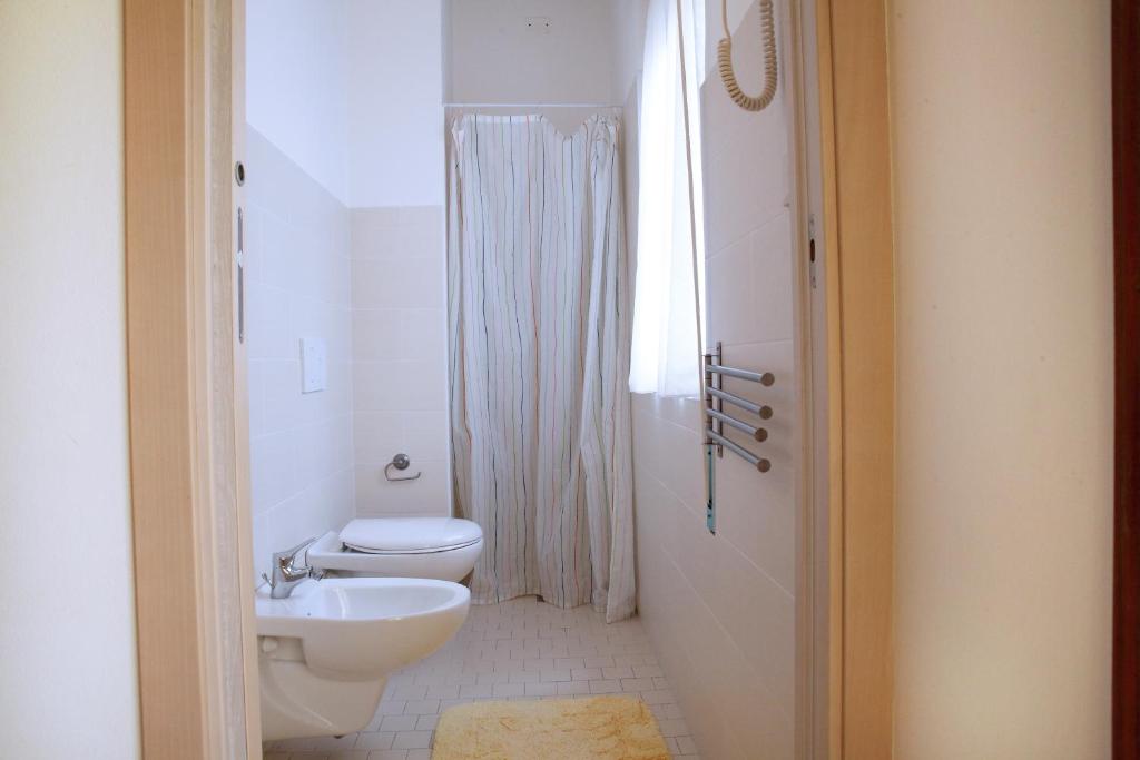 une salle de bain blanche avec toilettes et lavabo dans l'établissement Hotel Lagomaggio, à Rimini