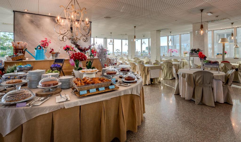 une grande salle de banquet avec des tables et des chaises. dans l'établissement Best Western Maison B Hotel, à Rimini