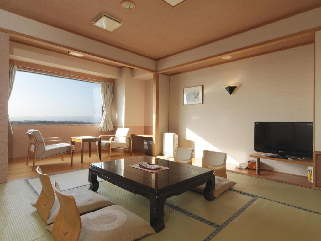 - un salon avec une table basse et une télévision dans l'établissement Hokuten no Oka Abashiriko Tsuruga Resort, à Abashiri