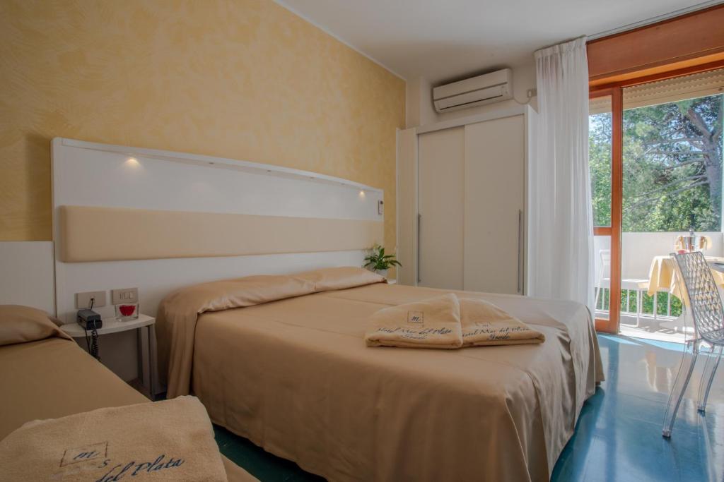 une chambre d'hôtel avec deux lits et une fenêtre dans l'établissement Hotel Mar Del Plata, à Grado 50 autres photos