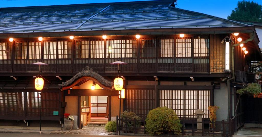 une maison japonaise avec des lumières sur la façade dans l'établissement Ryokan Kaminaka, à Takayama